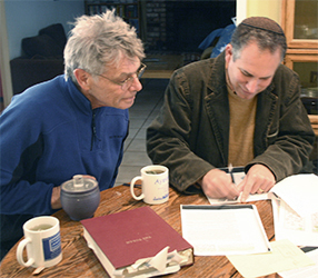 Rabbi George and Artist David Plachte-Zuieback confer on the text of the sactuary sidelight window