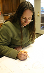 Michelle works on the details of the pattern for the sixth of the sanctuary sidelight windows