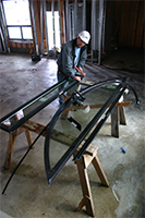 Glazers work on the frame for the window above the Aron Hakodesh