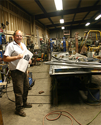 Owner, Larry Barndt checks dimensions against the plans for the steel frames