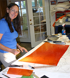 Michelle cuts glass in the cutting studio